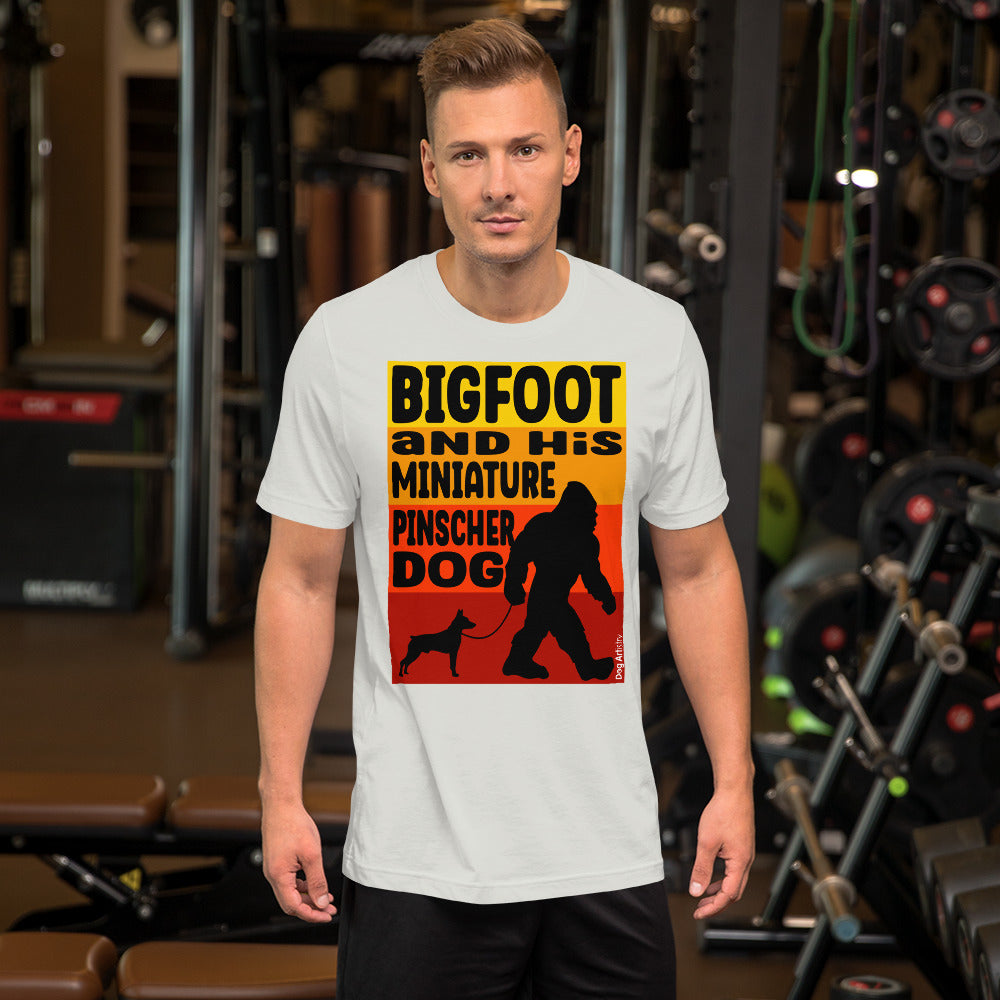 Bigfoot and his Miniature Pinscher unisex silver t-shirt by Dog Artistry.